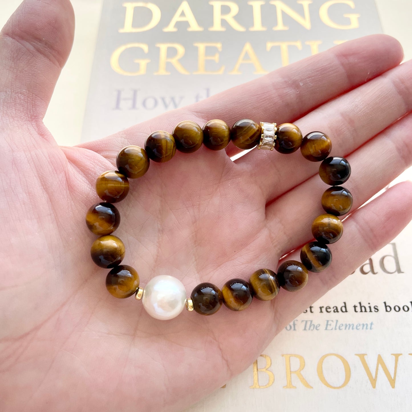 Large pearl bracelet courage on hand