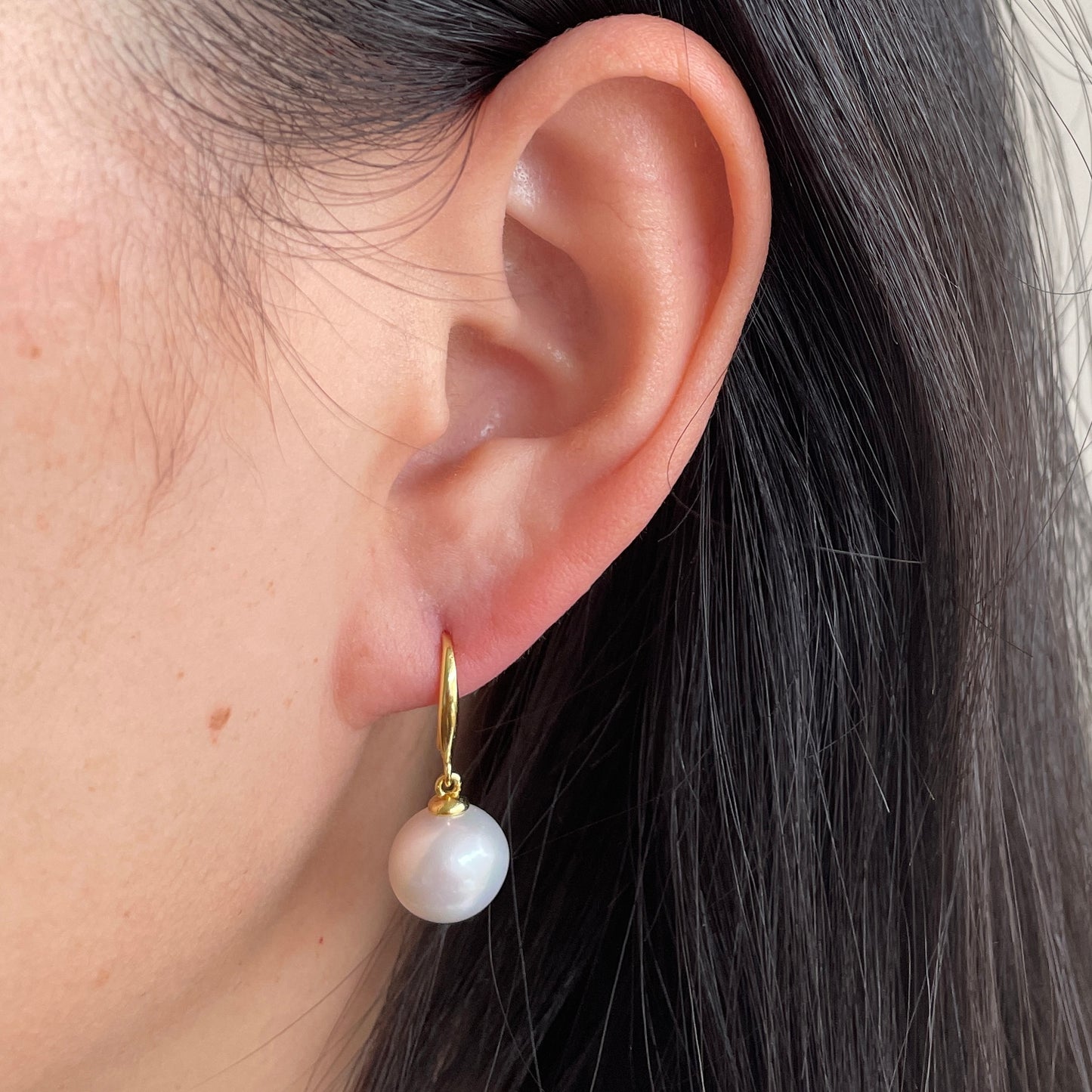 Pearl earrings on ear