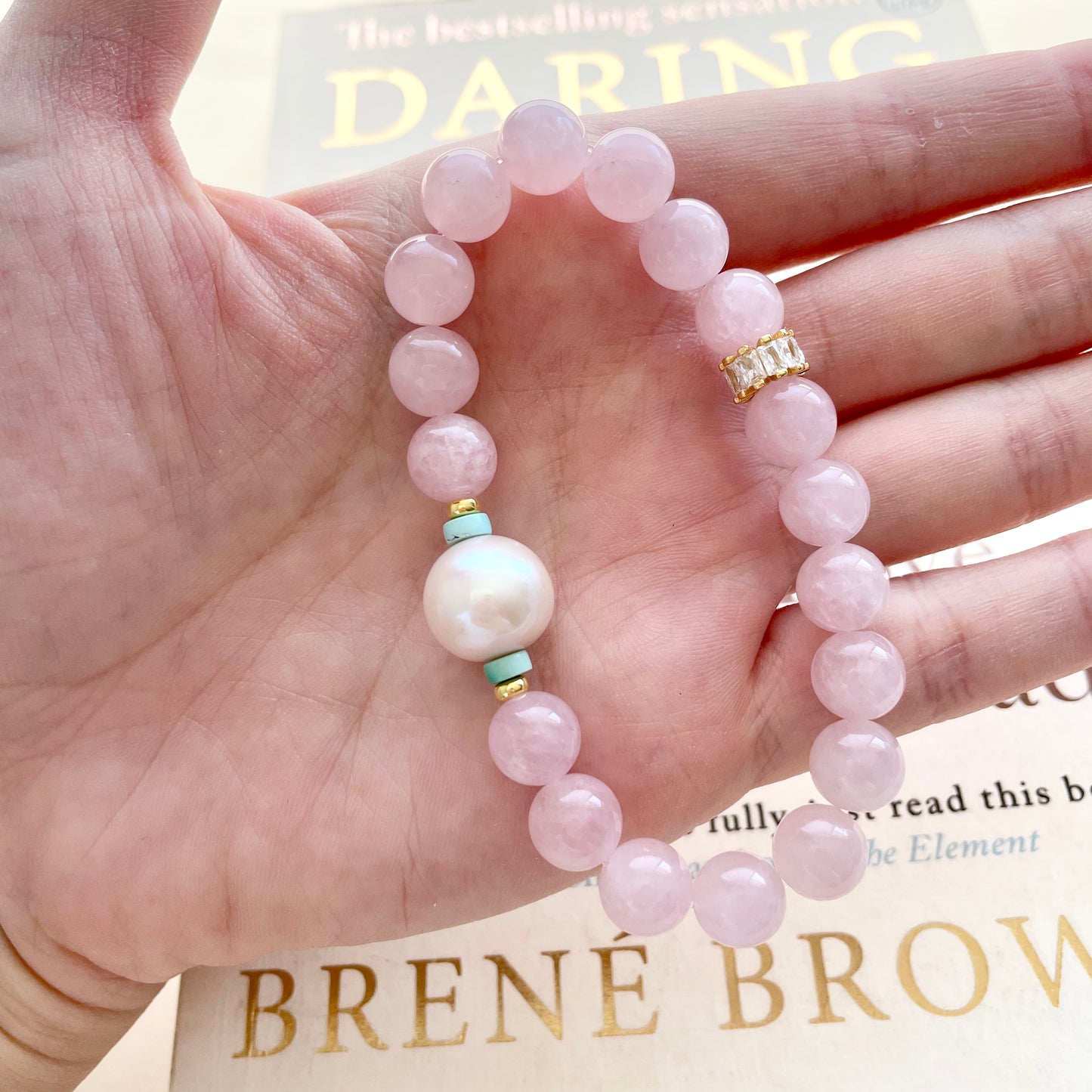 pearl and rose quartz bracelet on hand