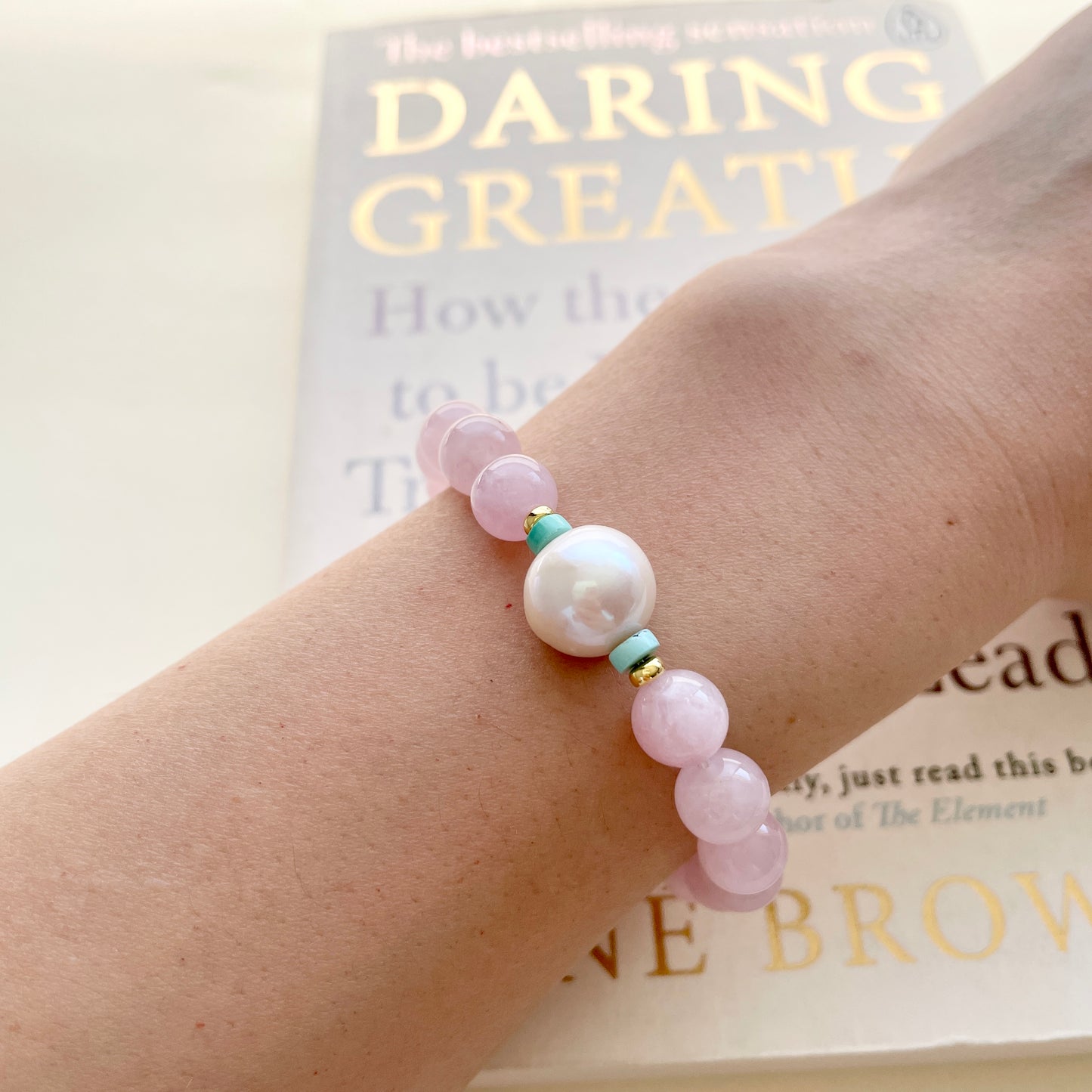 pearl and rose quartz bracelet on wrist