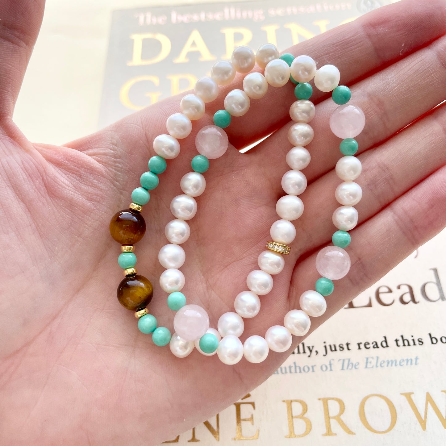 pearl bracelet kind and daring on hand