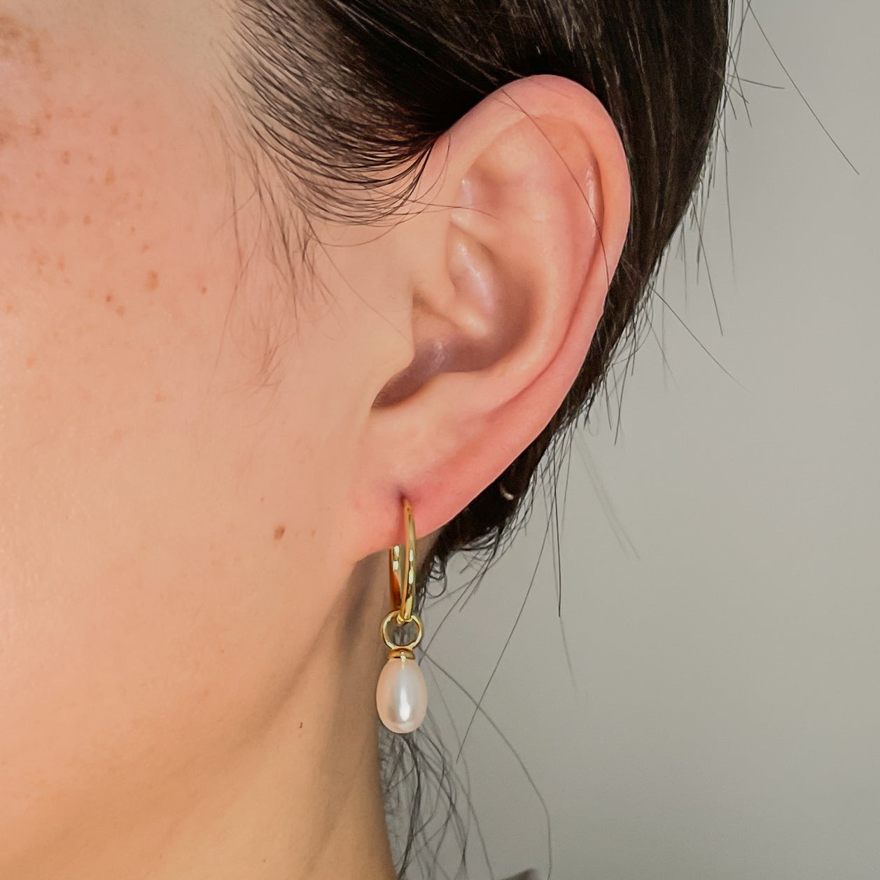 raindrop pearl earrings on ear