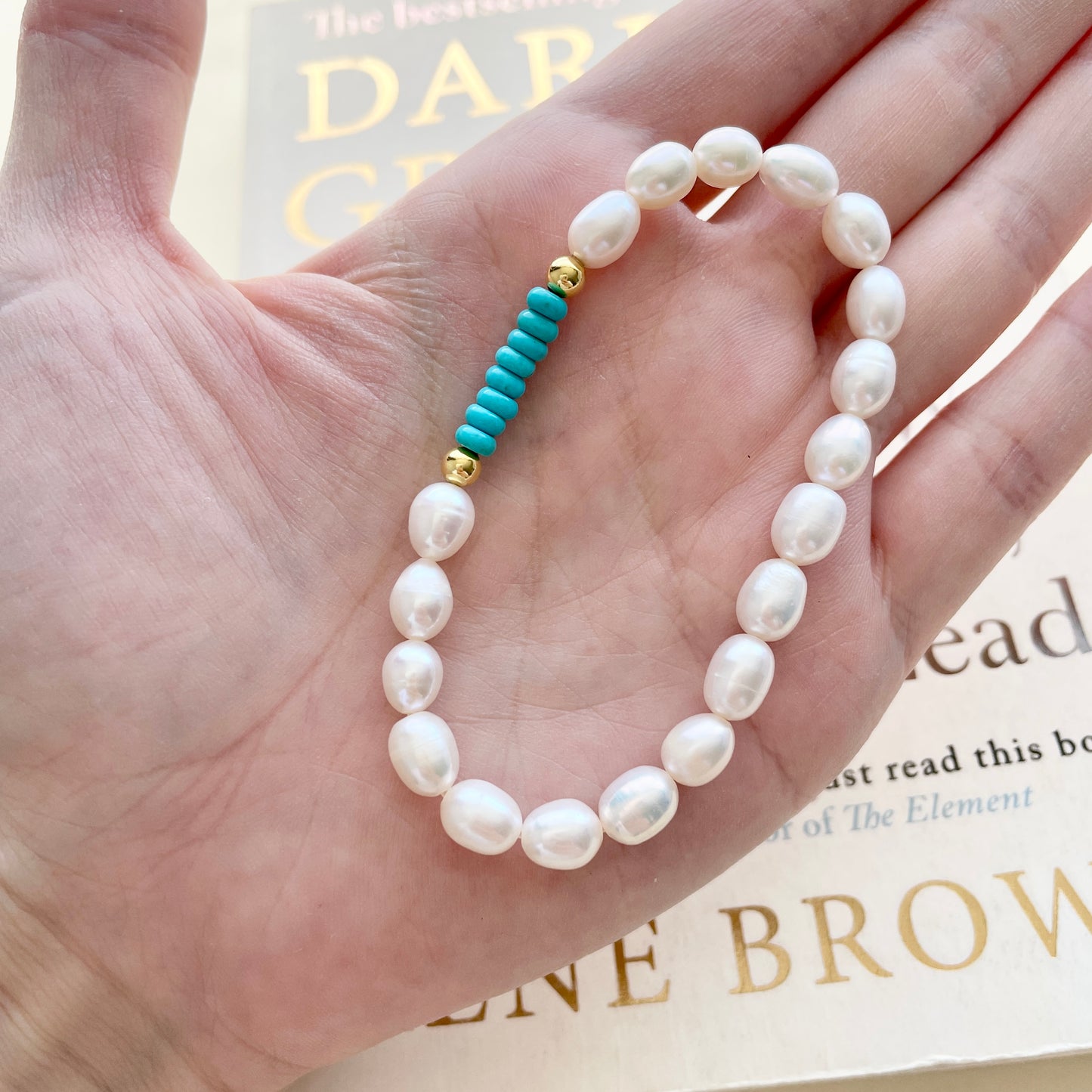 small pearl bracelet top on hand