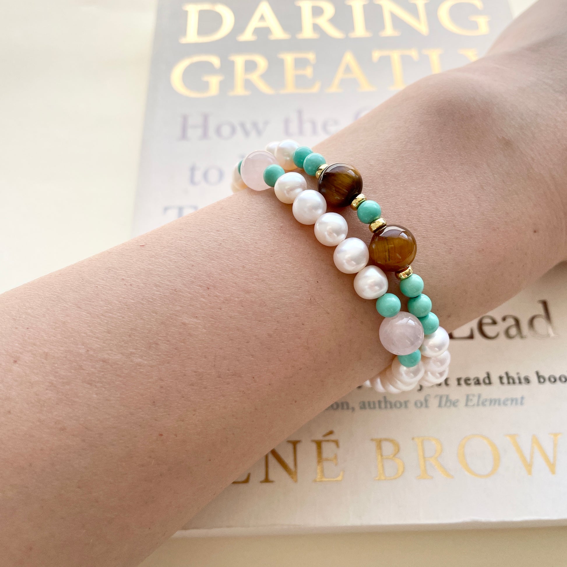 pearl bracelet kind and daring on wrist