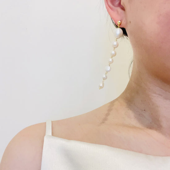 long pearl earrings on ear